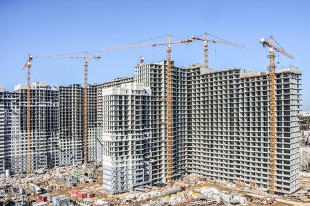 Construction of new residential buildings against the sky. The concept of the construction business.