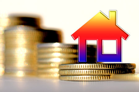 Real estate symbol on a background of white silver coins. The concept of changing investment markets.の写真素材