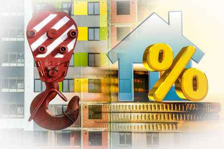 The percent symbol and real estate on a background of money. The concept of price changes on the real estate market.の写真素材
