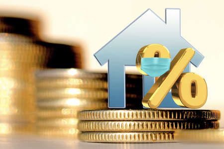 A symbol of real estate and interest in a medical protective mask on the background of money. The concept of changing the real estate market in a pandemic (covid-19).の写真素材