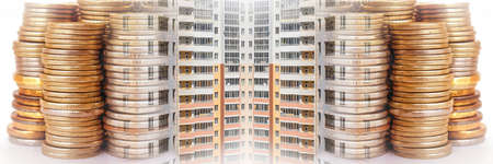 The facade of a residential high-rise house on a background of money. The concept of selling in the real estate market.の写真素材