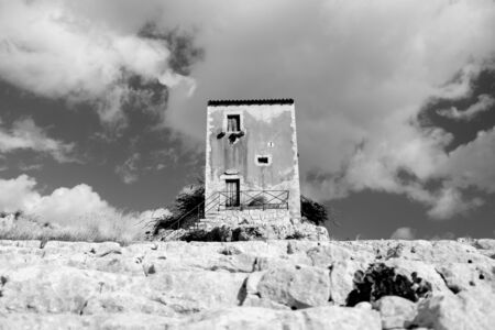 Siracusa, Sicilia, Italy - December 8 2019: Galerme windmill with the seats of the greek theater of...