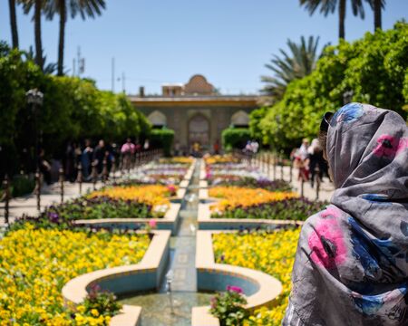 Shiraz, IRAN - April 24 2019: Woman with Hijab seen from backside in the Bagh-e Eram Gardenのeditorial素材