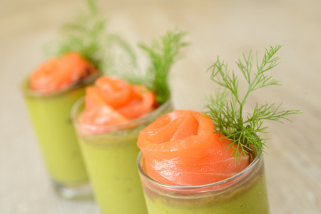 cups of appetizers with green sauce and salmon