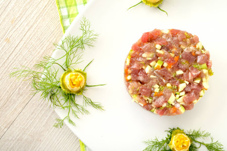 tuna tartare with celery, cucumber and zucchini flowersの写真素材