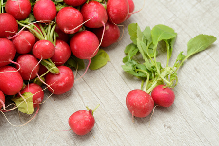red radishes on a wooden tableの写真素材