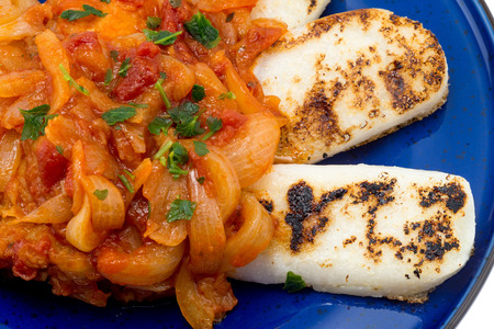 Cod with onions, tomato and white polentaの写真素材