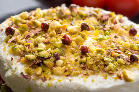 Pie with soft cheese and smoked salmon filling of chopped pistachios, served on a stone on the table...