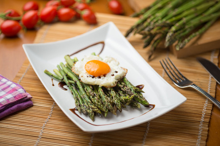 plate of asparagus baked with egg steamの写真素材