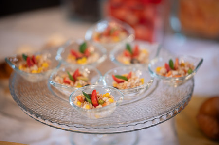 Close up of small appetizers in glass cups on the table.