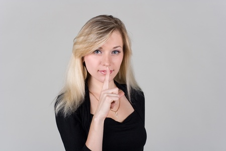 a girl shows a signの写真素材