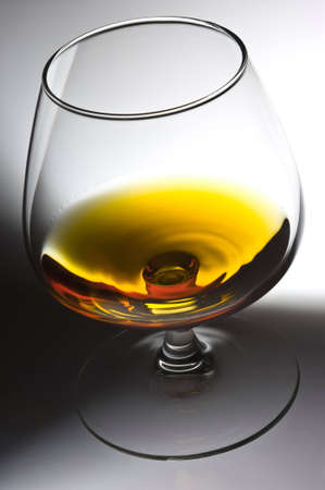 Glass with alcohol on a light backgroundの写真素材