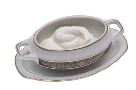 The dairy cream white is laid out by waves in a sauce-boatの写真素材