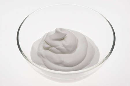 Dairy food -the dairy cream white is laid out by waves in a glass cupの写真素材