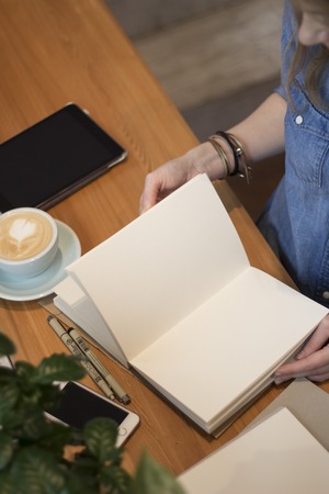A young girl flips through a clean album. Flat lay. Top viewの写真素材