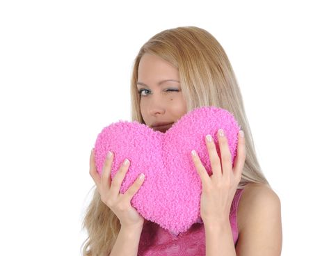 Beautiful girl with heart in hands winks. Isolated on white backgroundの写真素材