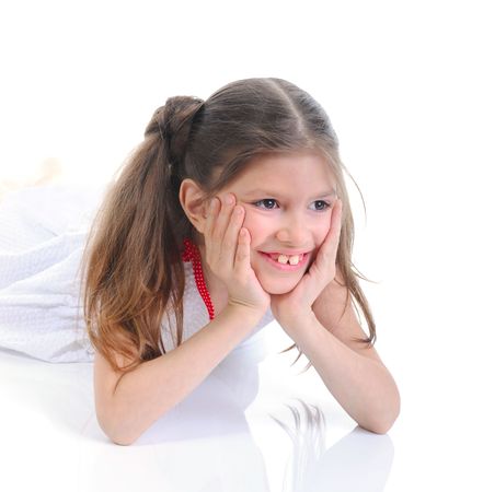 Portrait of the smiling six-year girl in a white dress.Isolated on white backgroundの写真素材
