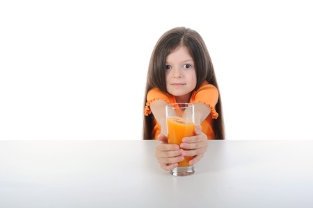 Girl with orange juice at the table. Isolated on white backgroundの写真素材