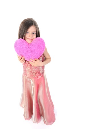 little girl in the evening keeps the heart. Isolated on white backgroundの写真素材