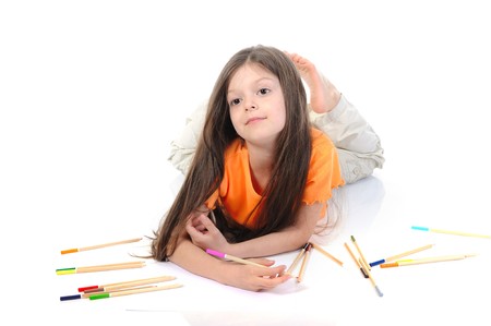 Little beautiful girl draws pencils. Isolated on white backgroundの写真素材