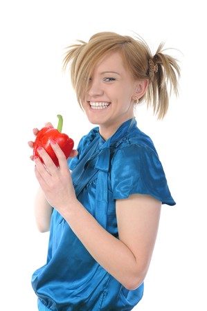 Beautiful smiling girl holding a red pepper. Isolated on white backgroundの写真素材