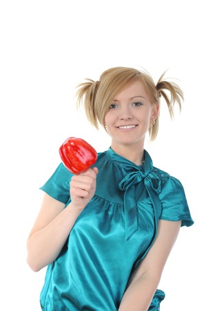 Young smiling girl holding a red pepper. Isolated on white backgroundの写真素材