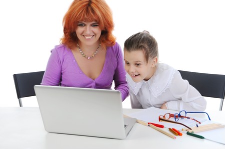 Mother and daughter at the computer. Isolated on white backgroundの写真素材