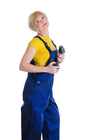 girl with a drill in building overalls. Isolated on white background の写真素材