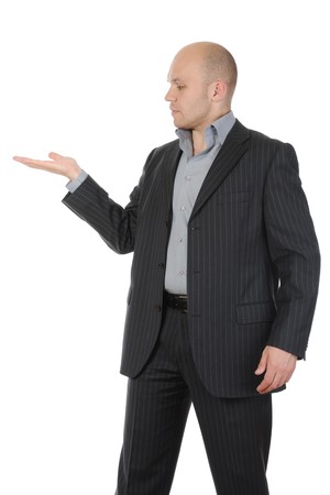 young man in a suit holds her hand, palm up. Isolated on white backgroundの写真素材