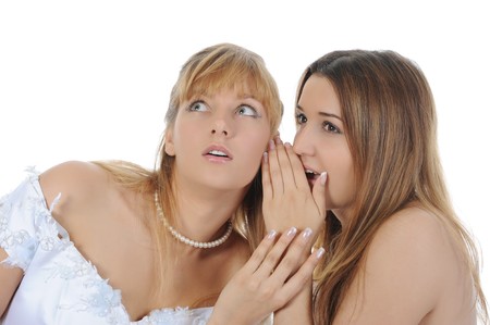 bride whispers to friend. Isolated on white backgroundの写真素材