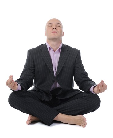 businessman meditating in yoga lotus. Isolated on white backgroundの写真素材
