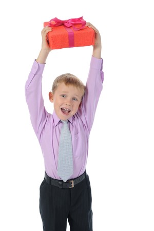 Joyful boy holding gift box . Isolated on white backgroundの写真素材