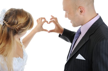 Newlyweds make heart fingers. Isolated on whiteの写真素材
