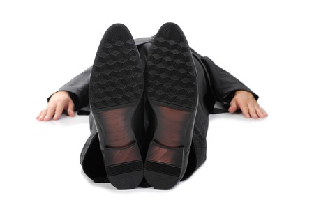 Businessman lying on the floor. Isolated on white backgroundの写真素材