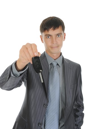 Businessman gives the keys to the car. Isolated on white backgroundの写真素材