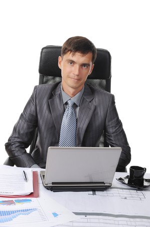 Businessman sitting before a laptop. Isolated on white backgroundの写真素材