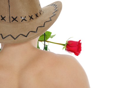 man in a hat holding a red rose in her teeth. Isolated on white backgroundの写真素材