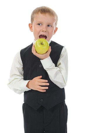 Boy eats a green apple. Isolated on white backgroundの写真素材