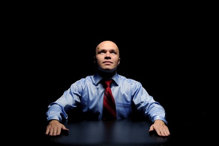 Portrait of young businessman in a dark roomの写真素材