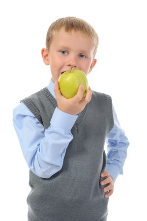 Boy eats an apple. Isolated on white backgroundの写真素材