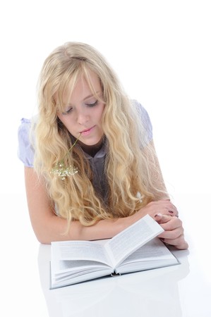 young woman reading book lying on the floor in a bright room. Isolated on white backgroundの写真素材