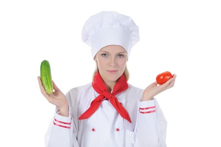 Portrait of a happy cook with fresh vegetables in the hands. Isolated on white backgroundの写真素材