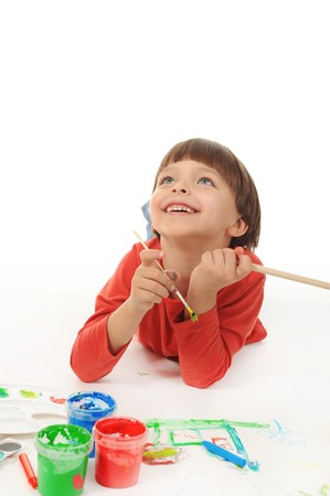 Little smiling boy learning to write. Isolated on white backgroundの写真素材
