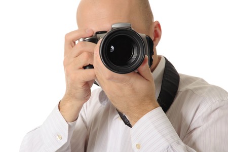 bald man holds a camera in his hands. Isolated on white backgroundの写真素材
