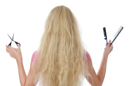young girl with backcombing hair and scissors. Isolated on white backgroundの写真素材