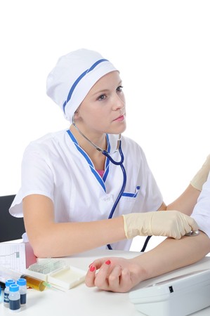 doctor measures the pressure of the patient in the clinic. Isolated on the white backgroundの写真素材