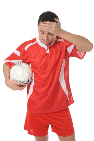 Upset soccer player in the red form.の写真素材