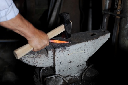 Making a decorative element in the smithy on the anvilの写真素材