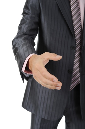 Businessman holds out his hand for a handshake. Isolated on white backgroundの写真素材