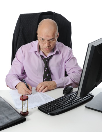 Businessman sitting before a computer. Isolated on white backgroundの写真素材
